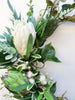 Image of Green and white wreath. Protea, thistle, eucalyptus. Australian christmas wreath, door decoration. Mossy vine wreath.