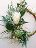 Image of Green and white wreath. Protea, thistle, eucalyptus. Australian christmas wreath, door decoration. Mossy vine wreath.