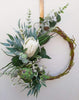 Image of Green and white wreath. Protea, thistle, eucalyptus. Australian christmas wreath, door decoration. Mossy vine wreath.